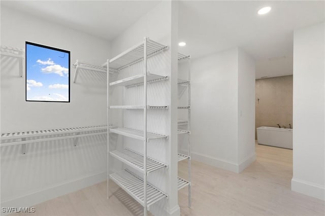 375 Periwinkle Ct, Marco Island, FL 34145 - walk in closet with wood finished floors