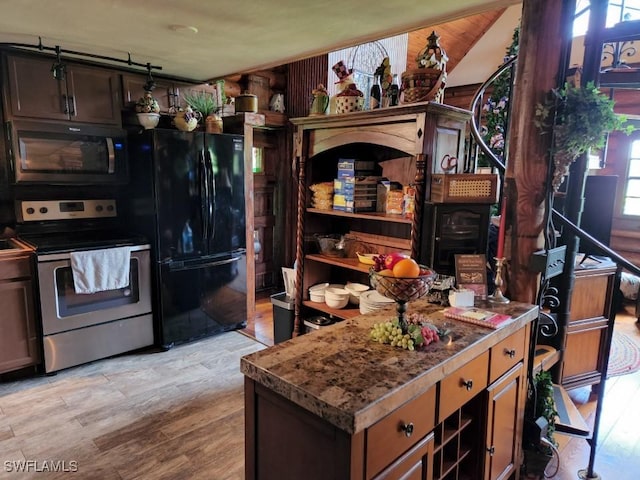 kitchen featuring appliances with stainless steel finishes and light hardwood / wood-style floors