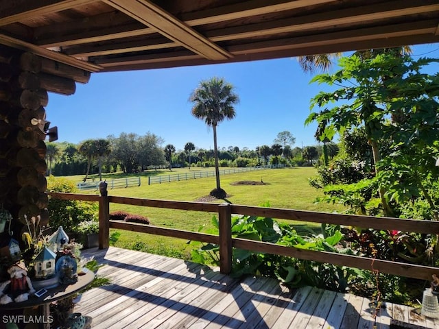 wooden deck with a yard and a rural view