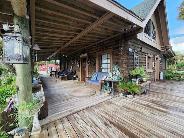 wooden terrace with an outdoor hangout area