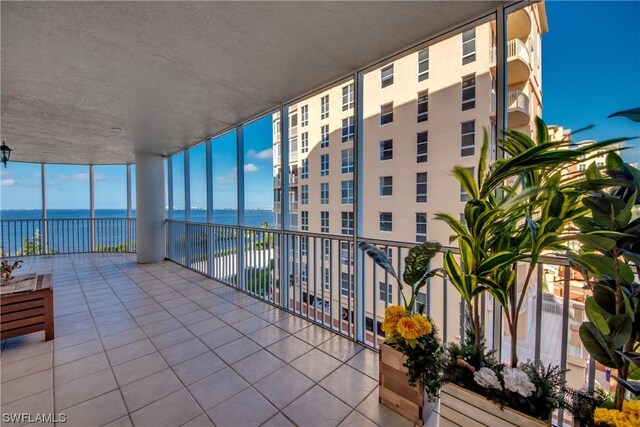 sunroom / solarium featuring a water view