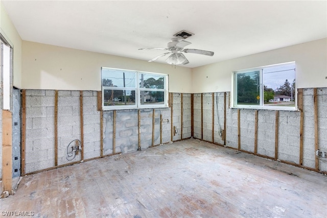 unfurnished room with ceiling fan and a healthy amount of sunlight