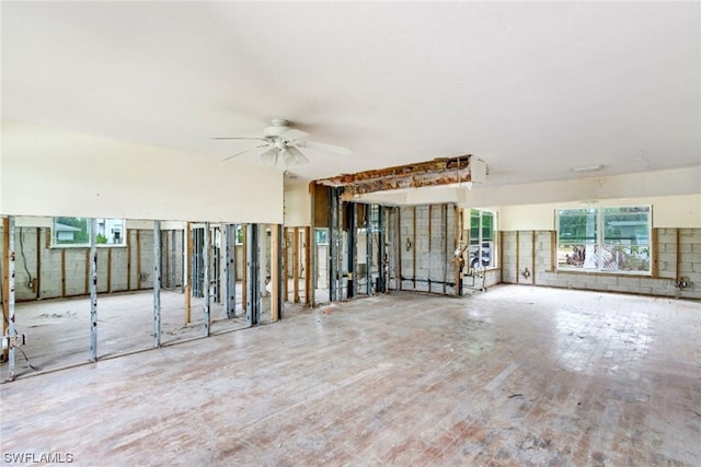 unfurnished living room with ceiling fan