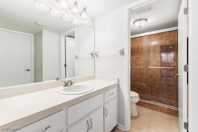 bathroom featuring tile patterned flooring, vanity, toilet, and walk in shower