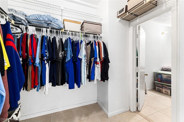 walk in closet with tile patterned flooring