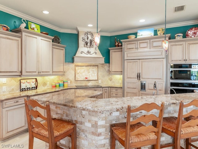 kitchen featuring wall oven, a kitchen breakfast bar, light stone countertops, and hanging light fixtures