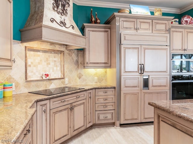 kitchen with custom exhaust hood, light stone countertops, black electric cooktop, and ornamental molding