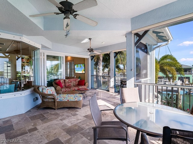 sunroom / solarium featuring ceiling fan