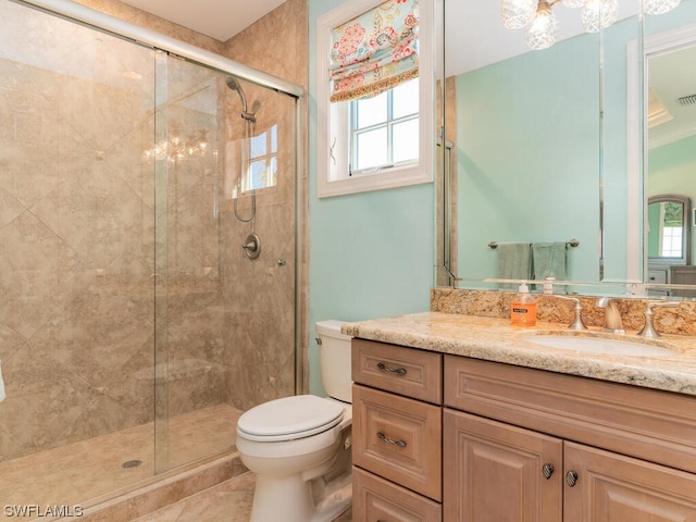 bathroom featuring toilet, vanity, an inviting chandelier, and walk in shower