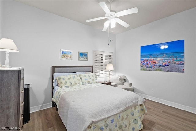 bedroom featuring dark hardwood / wood-style flooring and ceiling fan