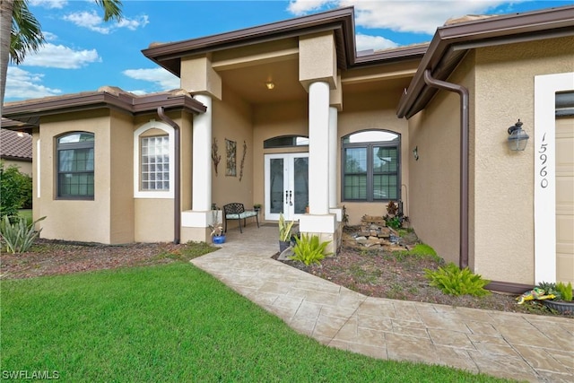 back of property featuring a yard and french doors