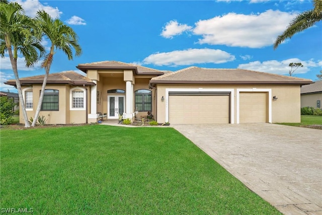 prairie-style home with a front lawn, a garage, and french doors