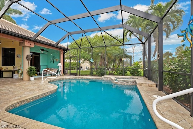 view of pool with a lanai, ceiling fan, an in ground hot tub, and a patio