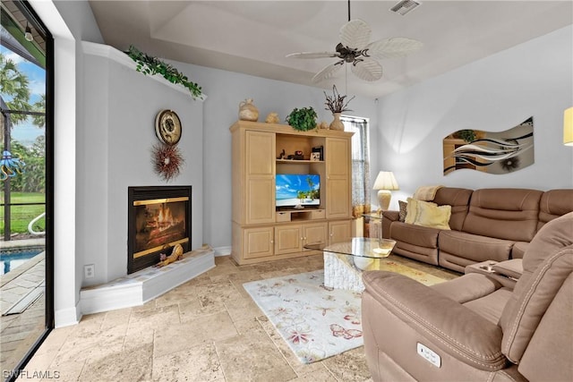 living room with plenty of natural light and ceiling fan