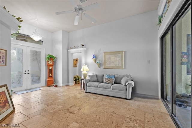 living room with ceiling fan and french doors