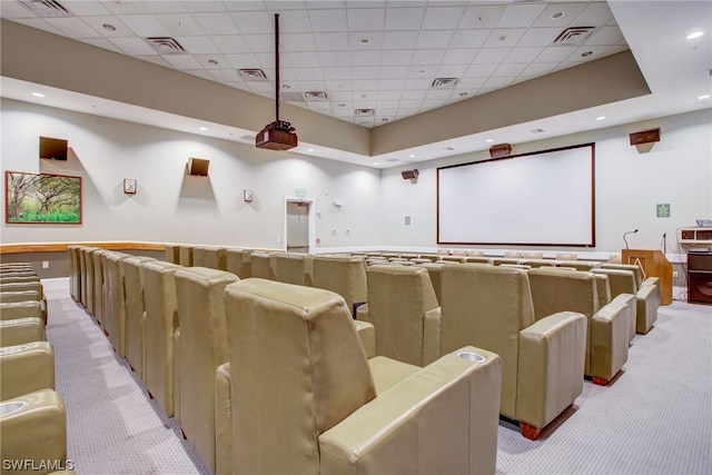 carpeted home theater room with a drop ceiling