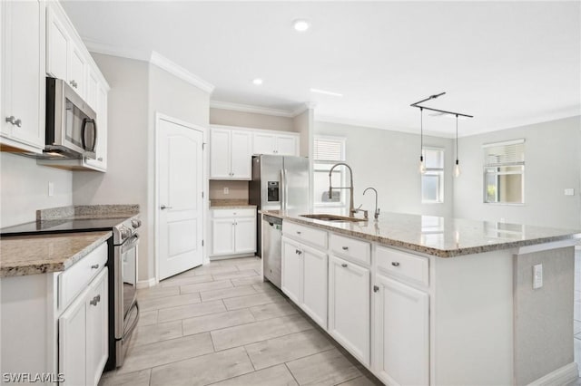 kitchen featuring white cabinets, appliances with stainless steel finishes, and a center island with sink