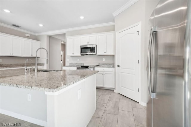 kitchen with light stone countertops, white cabinetry, sink, and stainless steel appliances