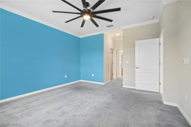 carpeted spare room featuring ceiling fan and ornamental molding