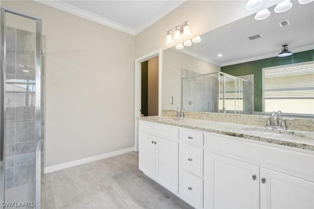 bathroom featuring hardwood / wood-style floors, vanity, crown molding, and walk in shower