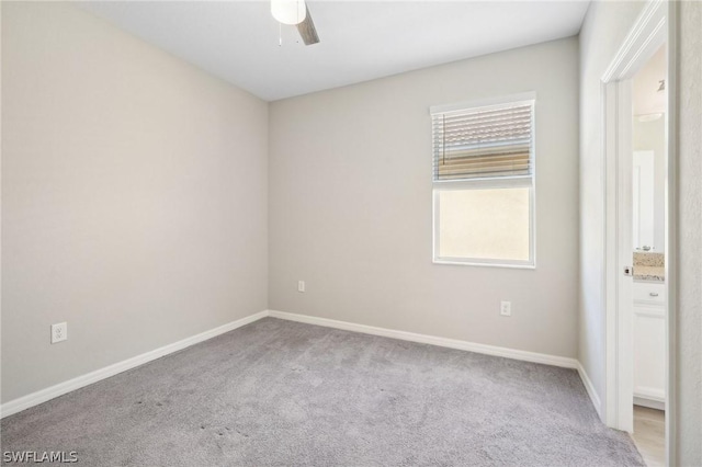 carpeted empty room featuring ceiling fan