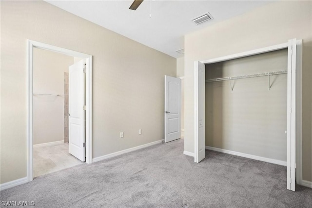 unfurnished bedroom with ceiling fan, a closet, and light colored carpet