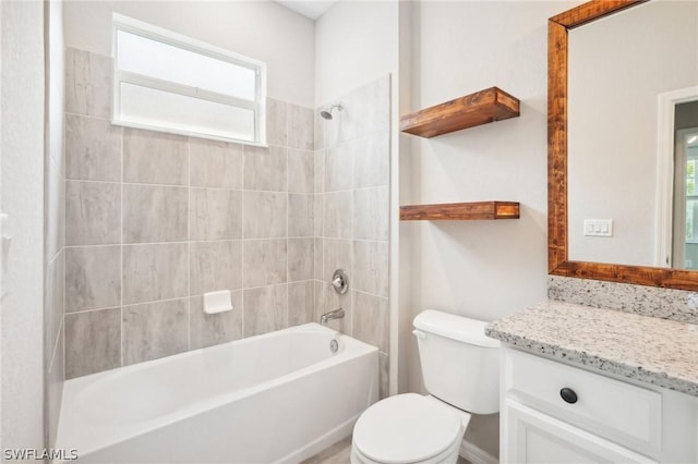 full bathroom featuring vanity, tiled shower / bath combo, and toilet