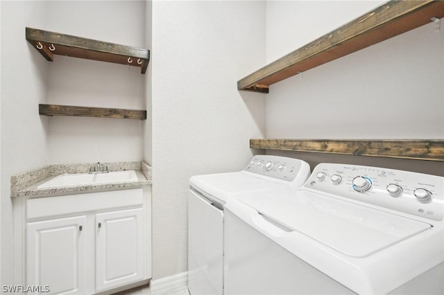 clothes washing area with sink and washer and dryer