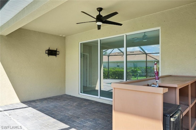 view of patio featuring ceiling fan and a lanai