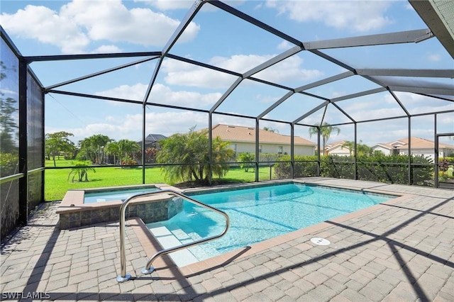 view of pool with an in ground hot tub, a yard, glass enclosure, and a patio area