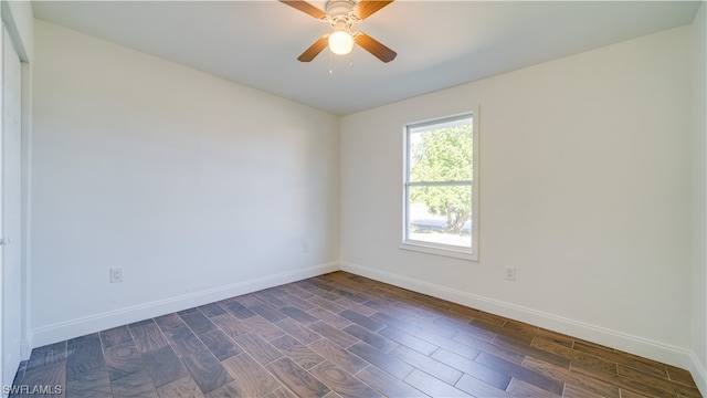 empty room with ceiling fan and dark hardwood / wood-style flooring