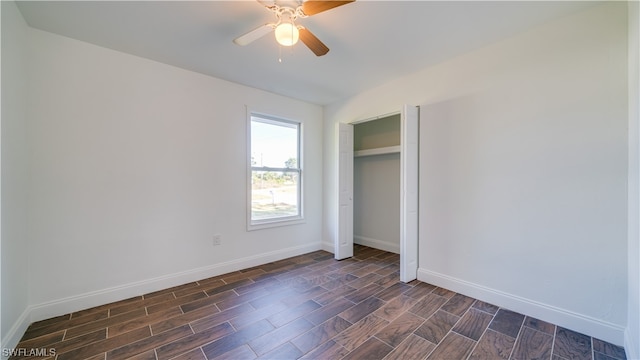 unfurnished bedroom featuring dark hardwood / wood-style flooring, ceiling fan, and a closet