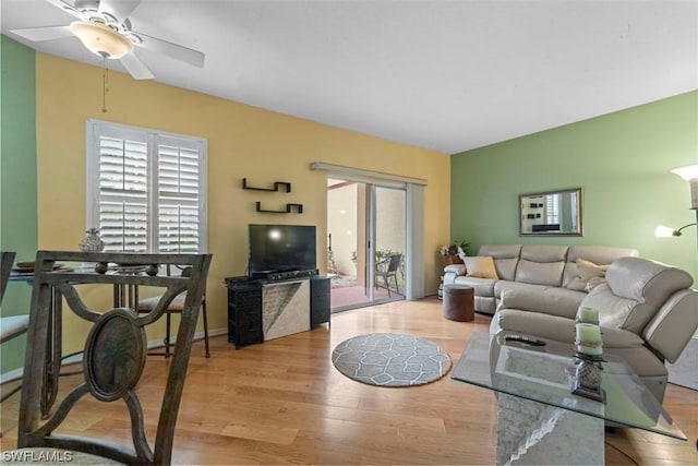 living room with light hardwood / wood-style floors and ceiling fan