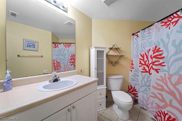 bathroom featuring vanity, tile patterned floors, and toilet