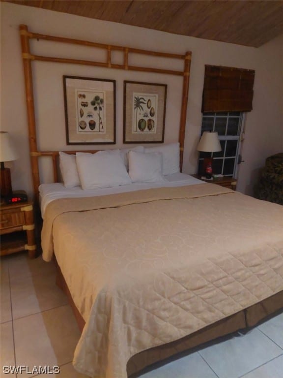 tiled bedroom featuring wood ceiling