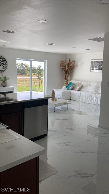 interior space with dark brown cabinets, dishwasher, and sink