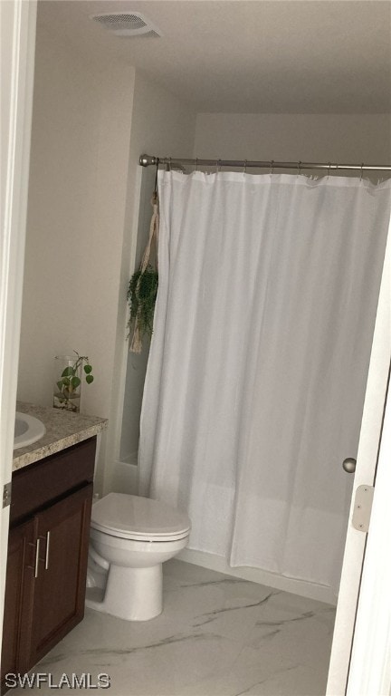 bathroom with vanity and toilet