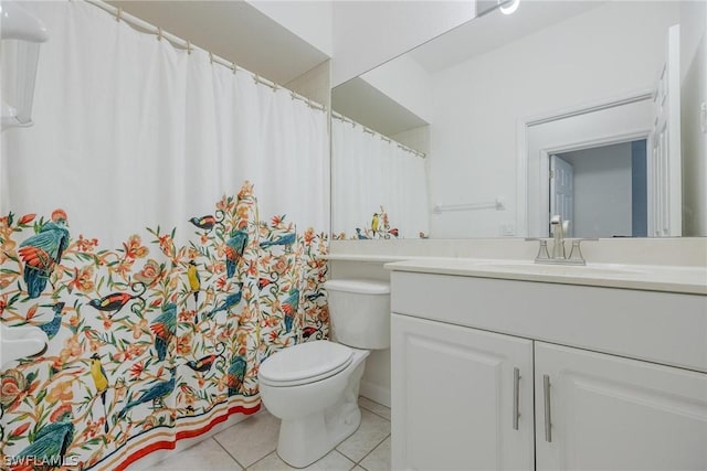 bathroom with tile patterned flooring, vanity, and toilet