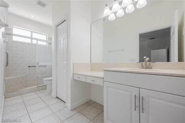 bathroom with vanity, toilet, an enclosed shower, and tile patterned flooring