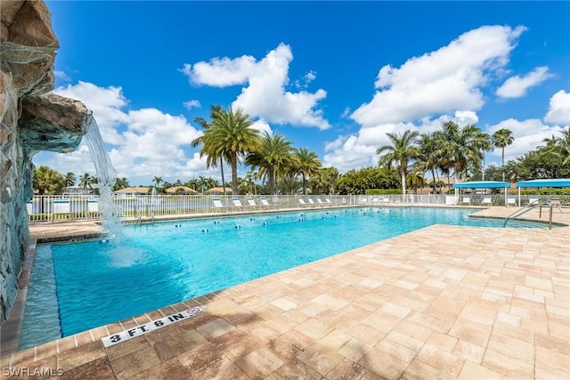 view of pool with a patio and pool water feature