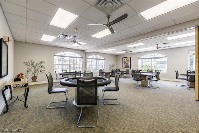 dining area with ceiling fan, a paneled ceiling, and carpet floors