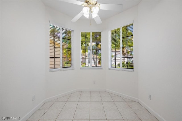 unfurnished room with light tile patterned floors and ceiling fan