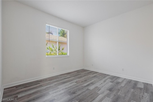 empty room with hardwood / wood-style flooring