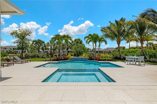 view of swimming pool featuring an in ground hot tub and a patio