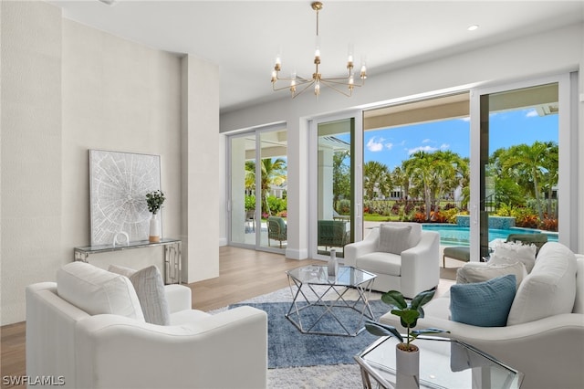 living room featuring a chandelier and light hardwood / wood-style flooring