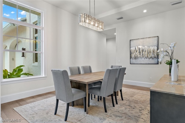 dining area featuring a wealth of natural light, a chandelier, and wood-type flooring