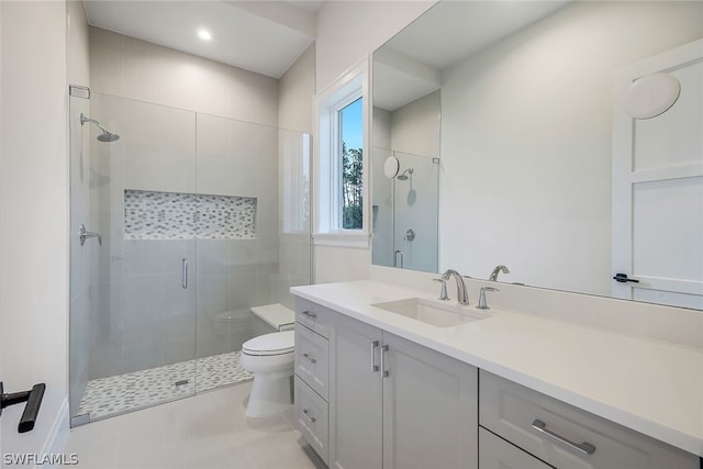 bathroom with tile flooring, walk in shower, vanity, and toilet