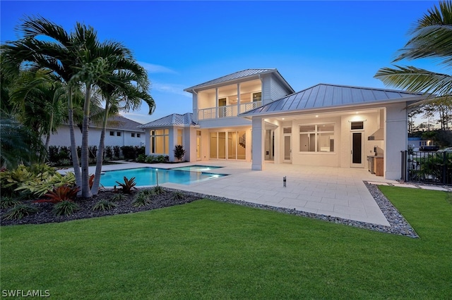 view of pool featuring a patio and a yard