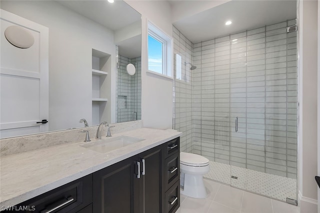 bathroom featuring tile flooring, a shower with door, built in shelves, toilet, and vanity