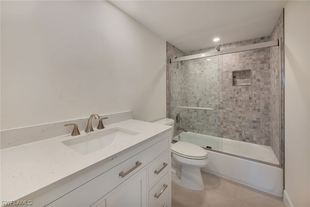 full bathroom featuring toilet, bath / shower combo with glass door, vanity, and tile flooring